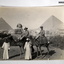 Two soldier on camels at the pyramids.