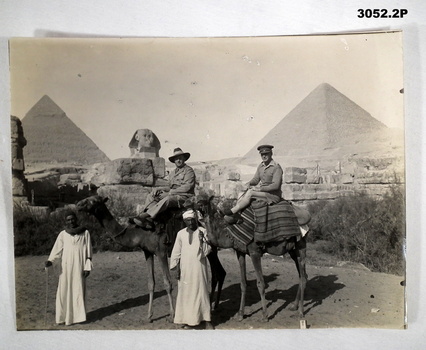 Two soldier on camels at the pyramids.