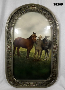 Coloured framed print of a soldier with two horses.