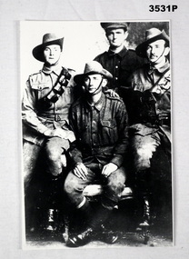 Black. White photograph of four soldiers.