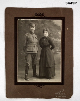 Sepia photo of a soldier and a women.