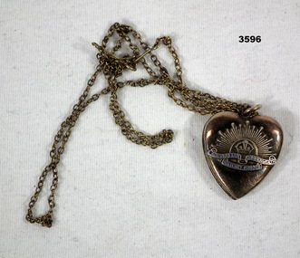 Heart shaped locket with Rising sun badge on.