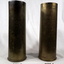 Two shell cases, one is engraved with names.