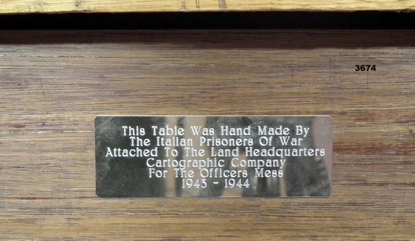 Plaque attached to the handmade wooden table