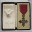 Showing OBE medal inside its case.