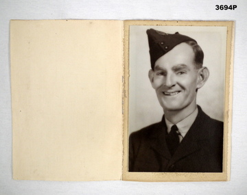 Portrait photo in folder re an RAAF airman.