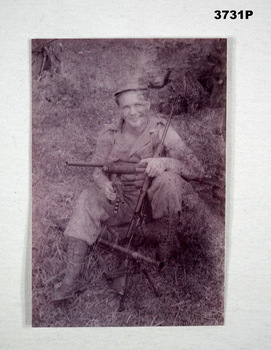 Black & White photograph of a soldier with four weapons.
