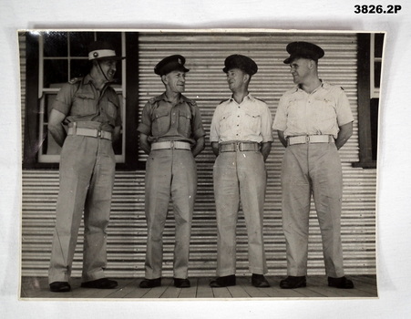 Two photographs of 4 Officers slightly different.
