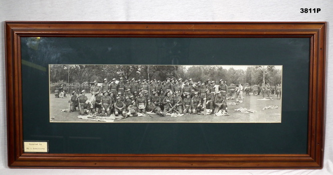Photograph, panorama of a group of soldiers with sign.