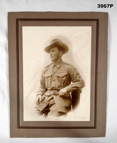 Sepia photo of a soldier on backing board WW1.