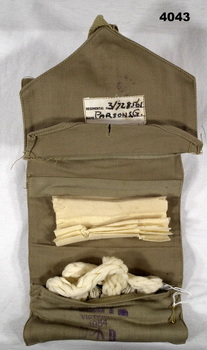 Sewing kit open showing some contents.