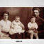 Sepia photo of a soldier with women and two children.