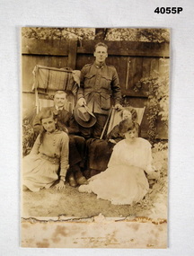 Photograph of a soldier with a family group.