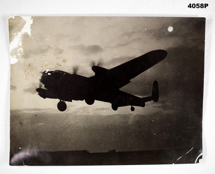 Lancaster Bomber in flight with moon in background