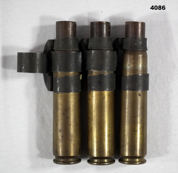 Three .50 Cal casings and link belt
