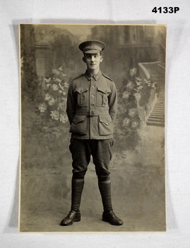 Studio B & W photo of a soldier standing