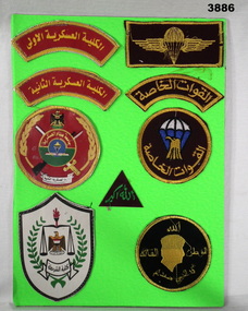 Colour patches Iraq mounted on green board.