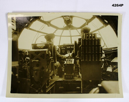 Photo with two pilots in cockpit.