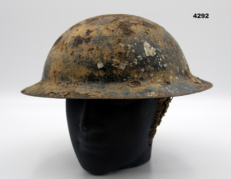 Steel British pattern helmet with chin strap.