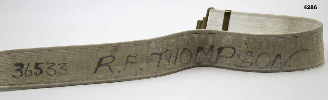 Underside of webbing belt with name on.