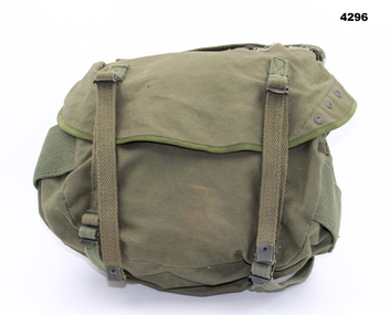 Small khaki backpack also known as a bum bag.  Worn around the waist below the main pack.