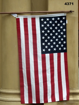 U.S.A. Flag mounted on a wood pole.