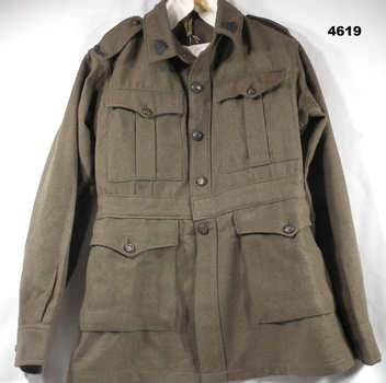 Khaki jacket complete with badges WW2
