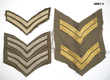Three types of Corporal rank insignia