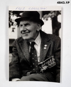 Collection of paper memorabilia, including photo of Fred Carleton.