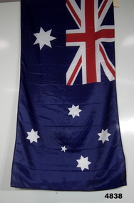 Australian Flag with display pole, with Inscription along hoist edge. This flag was flown over "The Security Detachment X Baghdad." 