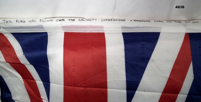 "This flag was flown over the Security Detachment X Baghdad on 15 Oct 2006." 