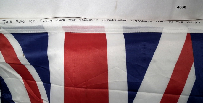 "This flag was flown over the Security Detachment X Baghdad on 15 Oct 2006." 