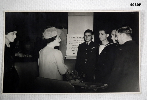 B & W Photo of Servicemen meeting the Queen consort.