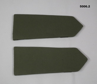 Pair of khaki coloured hard shoulder boards without rank insignia.
