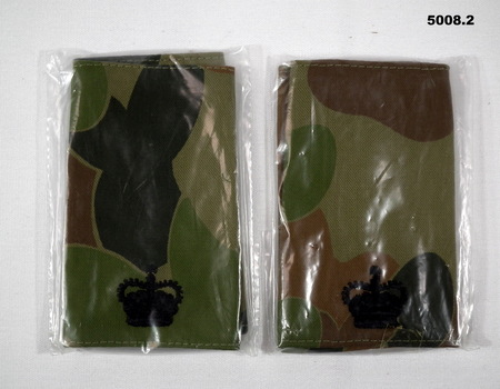 Two pairs of slide shoulder boards in camouflage pattern and featuring a major's insignia.