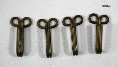 Brass Hooks for holding belt on uniform.