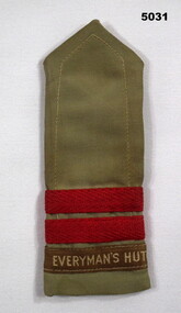 Khaki coloured slide shoulder board issued to a member of the 'Everyman's Hut' organization.