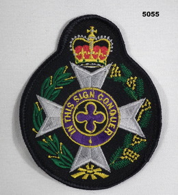 An army Christian chaplain's cloth badge worn on the upper left sleeve.
