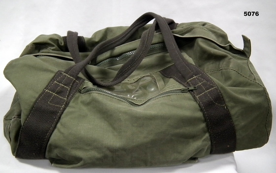 Green army issue kit bag for carrying personal equipment.