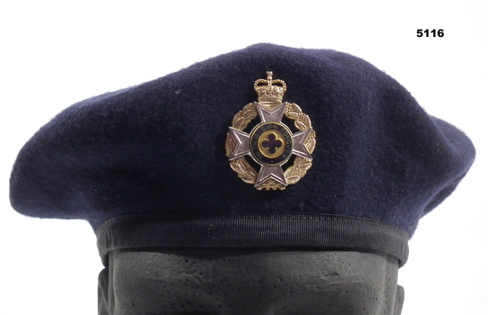 Navy blue beret with Australian Army Christian Chaplain's badge.