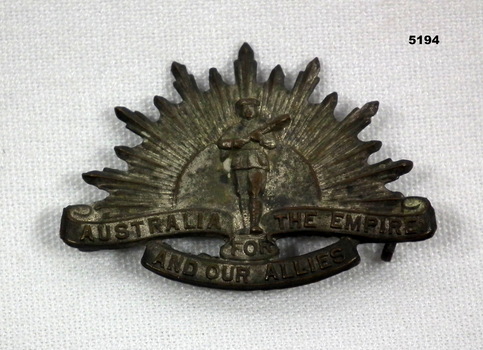 SOUVENIR BADGE, RISING SUN AND SOLDIER