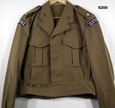 Khaki woollen battle dress jacket with major's insignia and chaplain's badge.