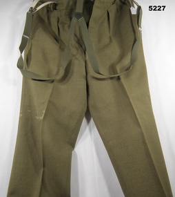 Khaki battle dress trousers in woolen fabric with braces attached.