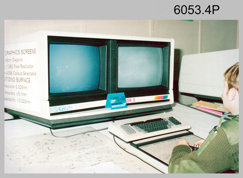 SPR Craig Kellet operating a AUTOMAP 2 Graphic Edit Workstation in Cartographic Squadron, c1984