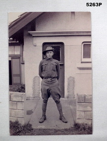 Photo of Soldier in front of house.