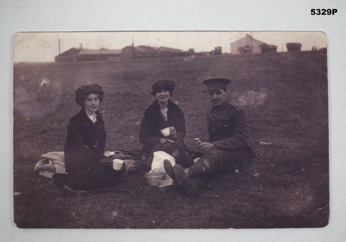 Three people having a picnic in WW1.