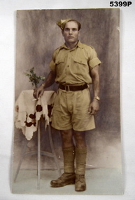 Coloured photo of a uniformed soldier in summer uniform.