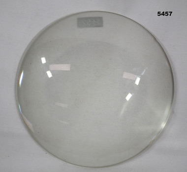 Large circular convex magnifying glass.