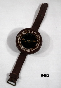 Wrist mounted brown coloured flying compass.