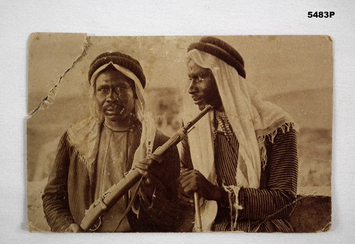 Postcard photograph of Bedouin soldiers holding rifles. Black and white dated 1921.